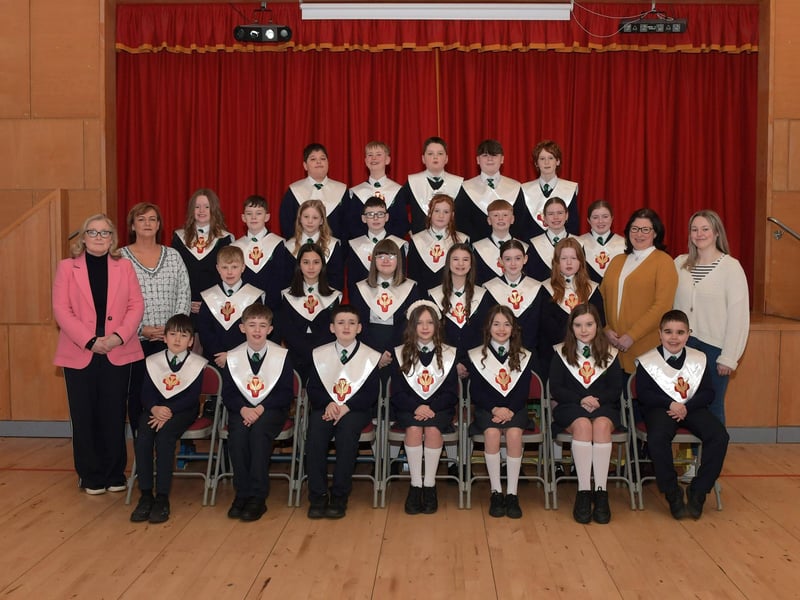 Pupils from St Patrick’s Primary School who recently made their Confirmation at St Patrick’s Church in Pennyburn. Included in the photograph are, from left, Mrs D. Moore (teacher), Miss O’Doherty, Miss O’Connell and Miss Devine (classroom assistants). Photo: George Sweeney