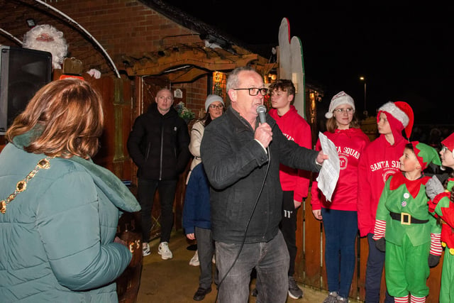 Santa looks on as Eddie Breslin joins the Mayor Councillor Patricia Logue who was on hand at Amelia Court in Steelstown to switch on the Christmas Lights and meet Mr and Mrs Claus whose Grotto officially opened for the festive period until Christmas Eve. This year donations are in aid of the Foyle Hospice and Macmillan Cancer Support. Picture Martin McKeown. 01.12.23