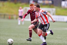 Derry City full back Ben Doherty races past Aodh Dervin of Galway last Friday night.