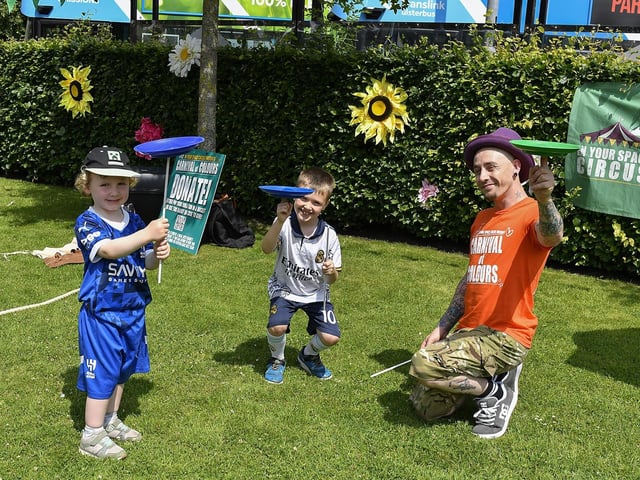 Brothers Jacob and Kayden spin plates, in the Peace Garden, during the Carnival of Colours Festival. Photo: George Sweeney