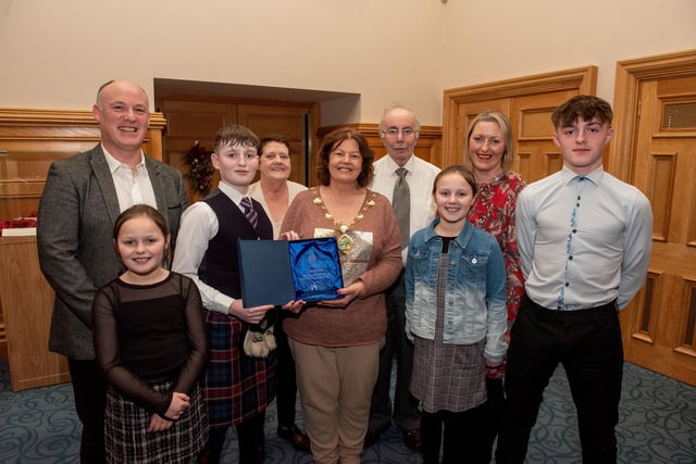 Twelve years old Jacob Laird from Bready Ulster Scots Pipe Band has been recognised by the Mayor Councillor Patricia Logue after he was crowned Ulster, All Ireland and World Champion solo snare drum champion. Pictured with Jacob are his mum and dad, Tanya and Ivor and grand parents Ann and Kenneth Scott and sisters Eve and Zara and brother Zac. Picture Martin McKeown.