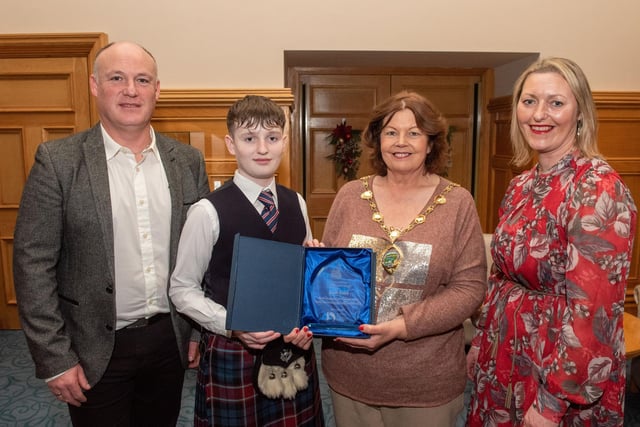 Twelve years old Jacob Laird from Bready Ulster Scots Pipe Band has been recognised by the Mayor Councillor Patricia Logue after he was crowned Ulster, All Ireland and World Champion solo snare drum champion. Pictured with Jacob are his mum and dad, Tanya and Ivor. Picture Martin McKeown.