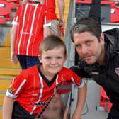 A young fan poses for a picture with Derry City manager Ruaidhri Higgins at the Brandywell on Friday evening. Photo: George Sweeney. DER2322GS – 118