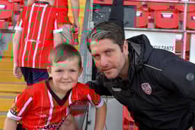 A young fan poses for a picture with Derry City manager Ruaidhri Higgins at the Brandywell on Friday evening. Photo: George Sweeney. DER2322GS – 118