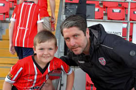 A young fan poses for a picture with Derry City manager Ruaidhri Higgins at the Brandywell on Friday evening. Photo: George Sweeney. DER2322GS – 118