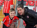 A young fan poses for a picture with Derry City manager Ruaidhri Higgins at the Brandywell on Friday evening. Photo: George Sweeney. DER2322GS – 118
