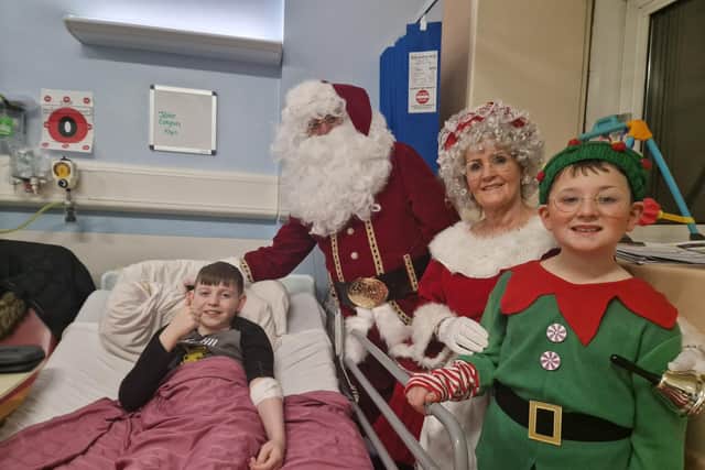 Ten year old Jake Colgan with Mr and Mrs Claus.