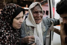 Palestinians injured in Israeli raids arrive at Nasser Medical Hospital on November 14, 2023 in Khan Yunis, Gaza. (Photo by Ahmad Hasaballah/Getty Images)