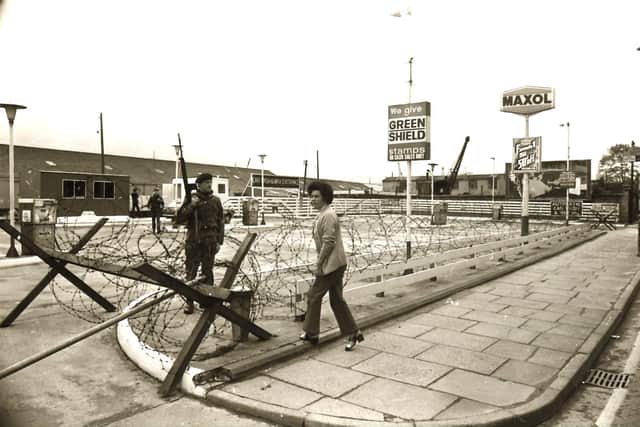 Barbed wire and British soldiers at a petrol station on the Strand Road during the Ulster Workers' Council strike in May 1974.