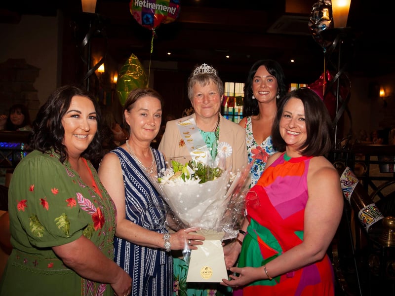 Ms. Linda Heaney receives a bouquet of flowers from colleagues at her retirement function in Da Vincis Hotel.
