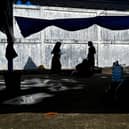 Rohingya refugees gather at a temporary camp, at a port in Sabang island, Indonesia's Aceh province on December 18, 2023. (Photo by CHAIDEER MAHYUDDIN / AFP) (Photo by CHAIDEER MAHYUDDIN/AFP via Getty Images)