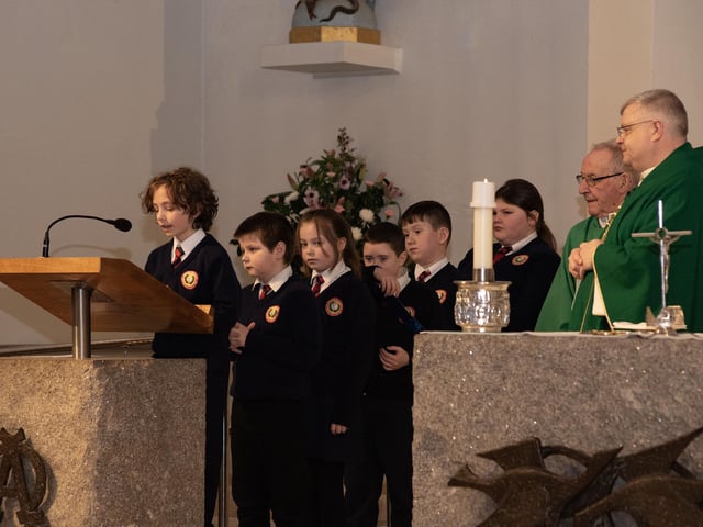 Some of the pupils reading during 'Grandparents To School' Mass.