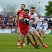 Derry’s Benny Herron evades a tackle from Tyrone's Cathal McShane during last season's' Ulster Championship clash.  Photo: George Sweeney. DER2218GS – 001