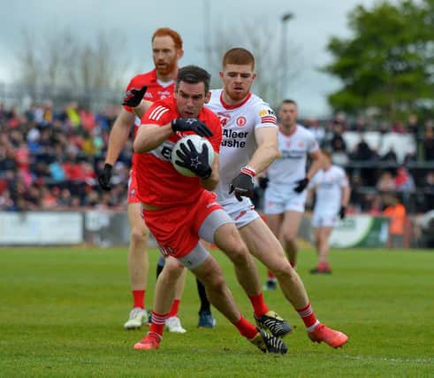 Derry’s Benny Herron evades a tackle from Tyrone's Cathal McShane during last season's' Ulster Championship clash. Photo: George Sweeney. DER2218GS – 001
