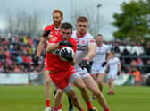 Derry’s Benny Herron evades a tackle from Tyrone's Cathal McShane during last season's' Ulster Championship clash.  Photo: George Sweeney. DER2218GS – 001