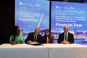 Mayor Lilian Seenoi Bar, NI Secretary of State Hilary Benn MP, Dr Caoimhe Archibald, Finance Minister and DSCDC Chief Executive Joh Kelpie sign the Financial Deal for Derry and Strabane region at the Guildhall on Wednesday morning. Photo: George Sweeney