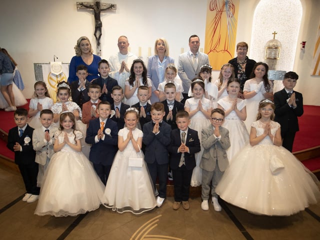 Pupils from Mrs. Fisher's class at St. Brigid's Primary School who received the Sacrament of First Holy Communion from Fr. Sean O'Donnell at St. Brigid's Church, Carnhill on Friday last. Included are Mrs. Eileen Fisher, Fr. Sean O'Donnell, Ms. Mary McCallion, Princpal, Mr. Kevin Fleming and Mrs. Iona Wiley, teaching assistants. (Photo: Jim McCafferty Photography)