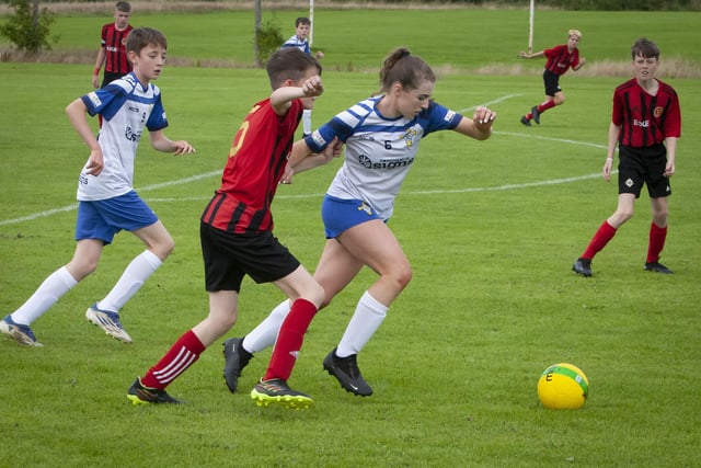 A very impressive Hannah O’Connor, St. John’s Athletic (Roscommon) holds off her marker in this midfield tussle against Hillsborough Boys at Templemore Sports Complex on Monday afternoon. (Photos: JIm McCafferty Photography)