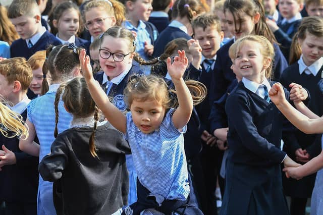 Children at Rosemount Primary School dance to the music and song of the Jive Aces on Thursday morning. Photo: George Sweeney