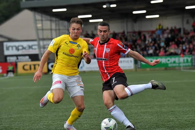 Derry City’s Michael Duffy holds off a tackle from KuP’s Seth Saarinen. Photo: George Sweeney. DER2330GS -