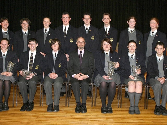 College principal Patrick O'Doherty, with students who collected school prizes at Lumen Christi College annual Prizegiving ceremony. Seated from left are, Therese Devine, James Mc Daid, Ryan Mc Closkey, Naomi Harvey, Elanor Coyle and Peter Gallagher. Standing from left are, Sally May Jackson, Naimh Mc Gee, Clare Gormley, Stephen Toland, Stephen McLaughlin, Peter Boyle, Maria Cutliffe and Jenny Grant. (1411T07).:Lumen Christi College prizegiving ceremony in 2003