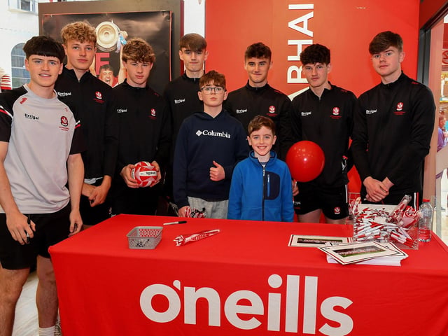 Ruairi and Jack McGrath pictured with members of Derry's All-Ireland Minor Champions team at O'Neill's Superstore last week. Photo: George Sweeney