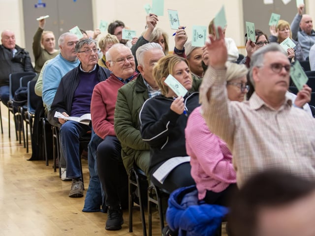 Derry Credit Union members taking part in one of the votes at Monday's AGM in St. Mary's College. (Photos: Jim McCafferty Photography)