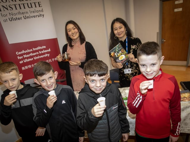 TEA TIME FOR PUPILS. . . .Checking out the quality of the Chinese tea during Saturday's Open Day at St. Columb's College.