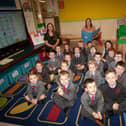 Miss Orla McNamara (centre), pictured with her P1 class at St. Brigid's PS this week. Included are Ms. Schmid, Classroom Assistant and Mrs. Mary McCallion, Principal.