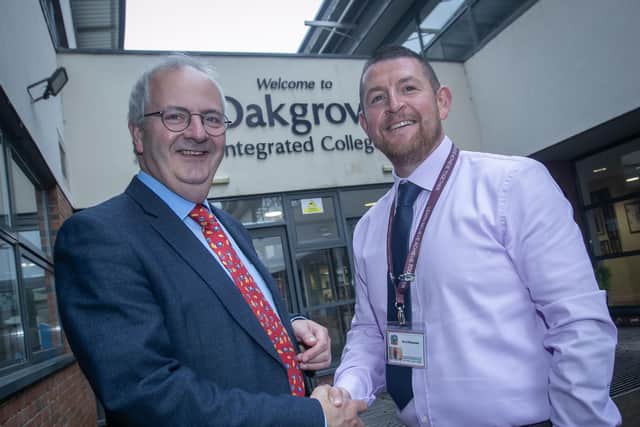 Mr. John Harkin, Principal, Oakgrove Integrated College, pictured on Wednesday morning congratulating teacher Mr. Keith McLaren who celebrates a quarter of a century with the school. (Photos: JIm McCafferty Photography)