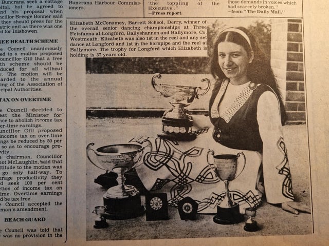The caption reads: "Elizabeth McConomey, Barrett School, Derry, winner of the overall senior dancing championships at Three Feisfanna at Longford, Ballyshannon and Ballymore, Co. Westmeath. Elizabeth was also 1st in the reel and any set dance at Longford and 1st in the hornpipe and the reel at Ballymore. The trophy for Longford which Elizabeth is holding is 37 years old."