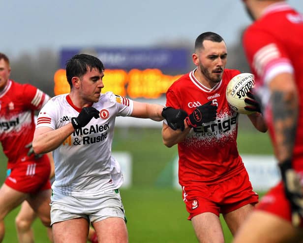 Michael Carty of Killeeshil holds off Craigbane's Conor McLaughlin. Photo: George Sweeney