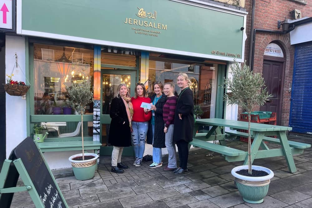 Members of Derry IPSC donating money to Jerusalem Coffee & Bakehouse.