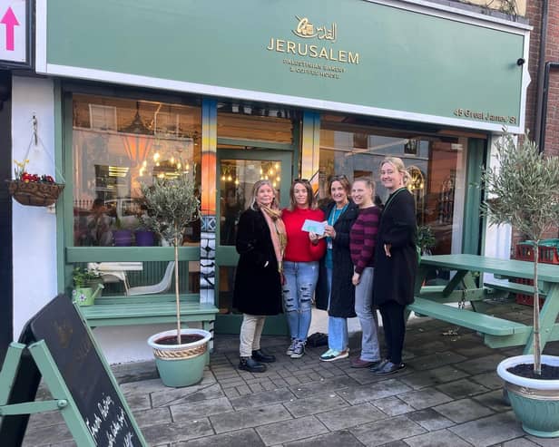 Members of Derry IPSC donating money to Jerusalem Coffee & Bakehouse.