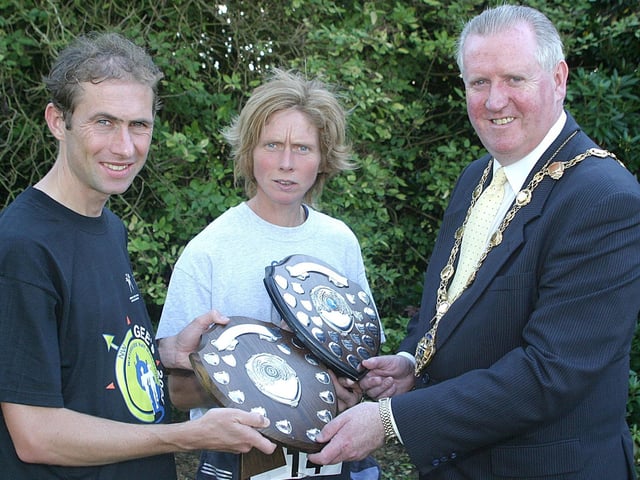 The Mayor of Derry Councillor Shane Gallagher, presents prizes to Paul Rowan (Willowfield), who was the first male to finish the Waterside Half-Marathon and Lugy Brennan, from Sligo, the first female to finish. (1609T56).:.