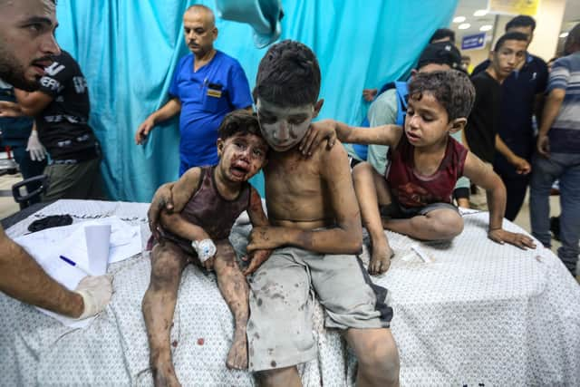 KHAN YUNIS, GAZA - OCTOBER 24: Palestinians injured in Israeli air raids arrive at Nasser Medical Hospital on October 24, 2023 in Khan Yunis, in the southern Gaza Strip, Gaza. Two weeks after a deadly Hamas attack in southern Israel that sparked a retaliatory siege of Gaza, in which thousands have died and hundreds of thousands have been displaced, aid trucks have started entering the Palestinian territory via Egypt carrying food, water and medicines. The UN agency UNRWA, or the Relief and Works Agency for Palestine Refugees, says the initial aid is a "drop in the ocean" of what is needed. (Photo by Ahmad Hasaballah/Getty Images)