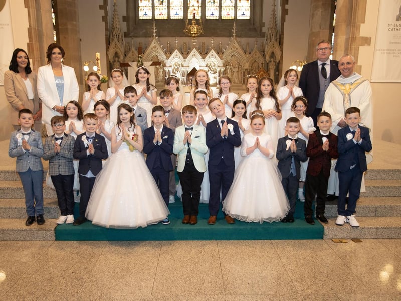 Children from Rosemount Primary School who received the Sacrament of First Holy Communion from Fr. Paul Farren at St. Eugene's Cathedral on Friday last. Included are Mrs. McSheffrey, Mrs Aisling McMenamin, teacher and Mr. Brady. (Photos: Jim McCafferty Photography)