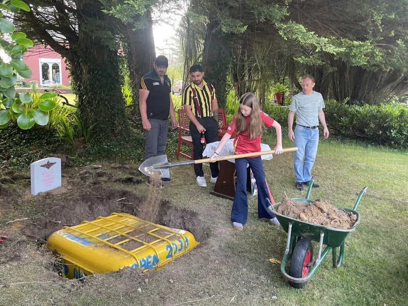Abbi burying the time capsule and memory book.