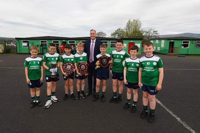 Education Minister Paul Givan pictured with the gaelic football team during his visit to the  Naíscoil Dhoire and Bunscoil Cholmcille, Steelstown, on Wednesday morning. Photo: George Sweeney