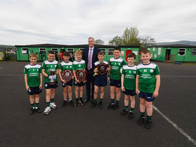 Education Minister Paul Givan pictured with the gaelic football team during his visit to the Naíscoil Dhoire and Bunscoil Cholmcille, Steelstown, on Wednesday morning. Photo: George Sweeney