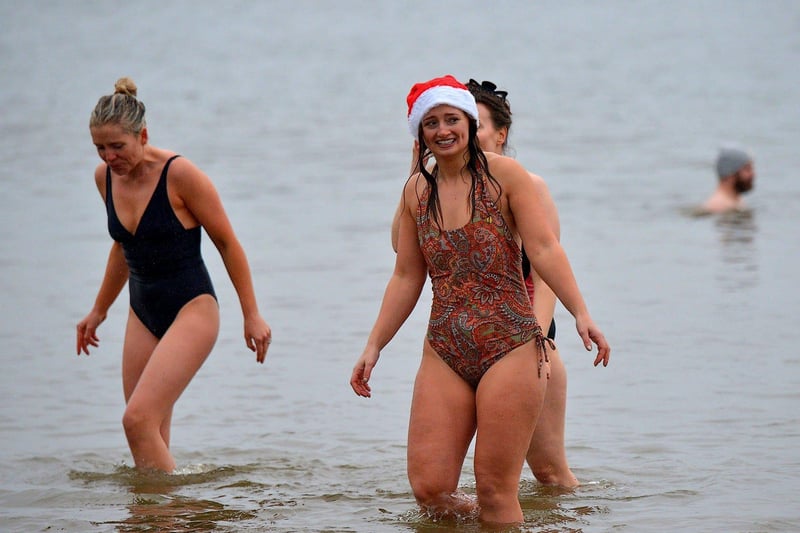 Swimmers brave the elements to take part in the annual Christmas morning charity swim at Ludden beach. Photo: George Sweeney. DER2252GS – 07