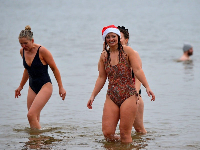 Swimmers brave the elements to take part in the annual Christmas morning charity swim at Ludden beach. Photo: George Sweeney. DER2252GS – 07