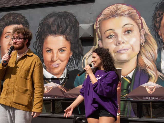 The Fame cast performing at the Derry Girls mural