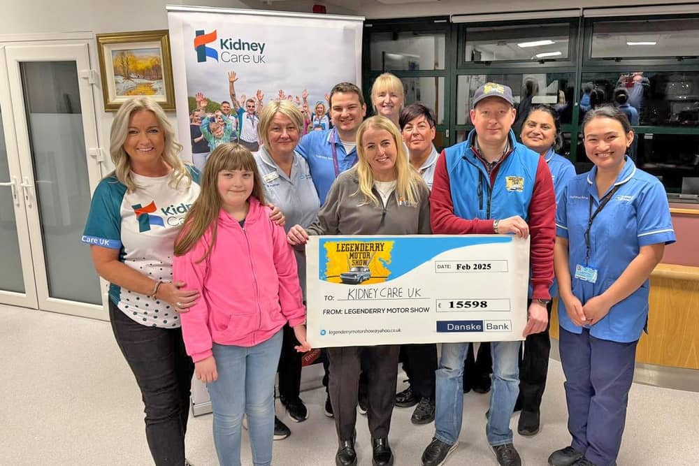 Attending the Legenderry Motor Show cheque presentation at Altnagelvin Hospital Renal Unit were staff from Altnagelvin Renal Unit with Jo-Anne Dobson – NI Ambassador for Kidney Care UK alongside Legenderry Motor Show organiser Richard Gillespie with his daughter Rachel and kidney recipient Heather Vance.
