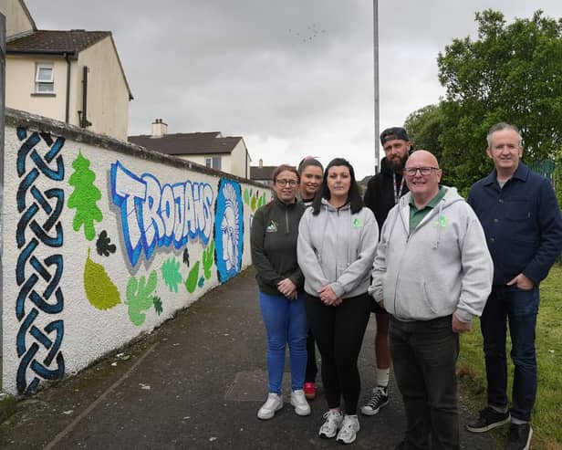 Art at the heart of Creggan….Pictured with Dene Harley (back, middle), Housing Executive Neighbourhood Warden at the newly transformed Bligh’s Lane site are, (from left) Tina Burke, Caoimhe Cooke, Rachel Mullan, Kevin Campbell and Gareth Stewart, Triax Neighbourhood Management Team.