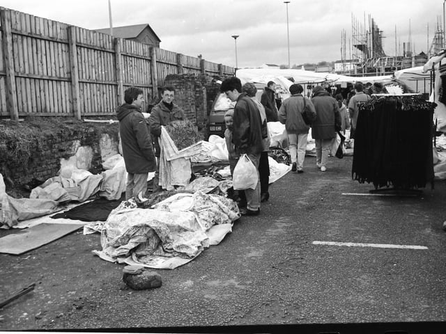 Traders and shoppers chat at the old Foyle Street market.