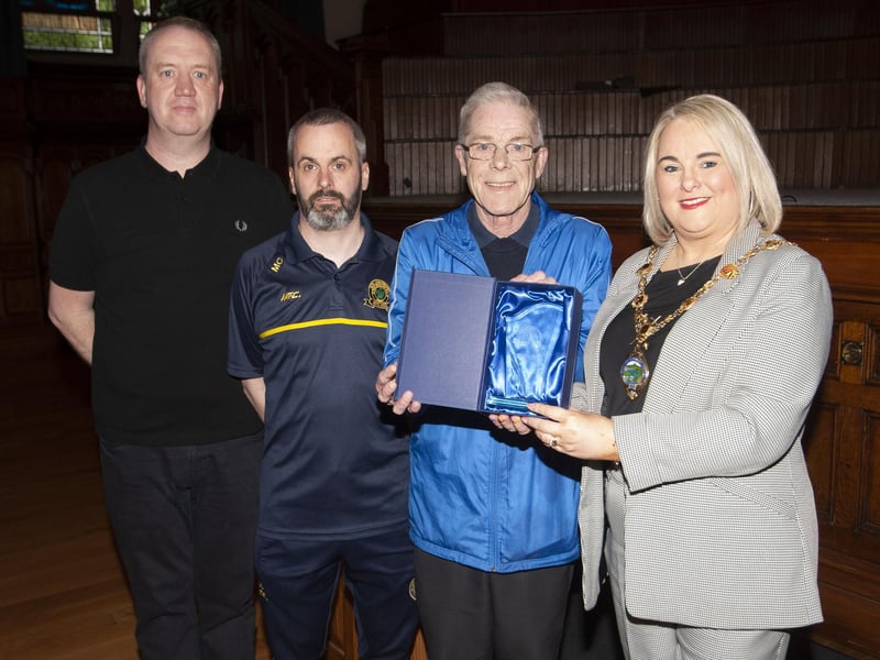 Hen McDaid receiving a presentation from the Mayor, Sandra Duffy in recognition of his long service to Don Boscos FC, at Friday night’s 50th Anniversary Reception in the Guildhall. ON left is Liam McGilloway, club secretary and Marty Crumley, chairperson.