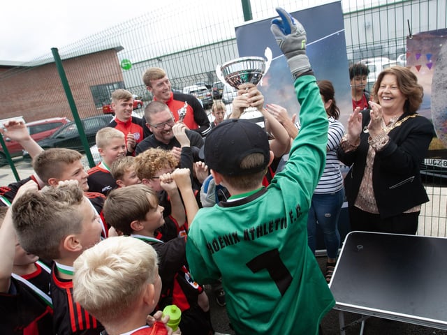Phoenix Athletic celebrate their victory at the Padraig Barton Cup at Bay Road Soccer.