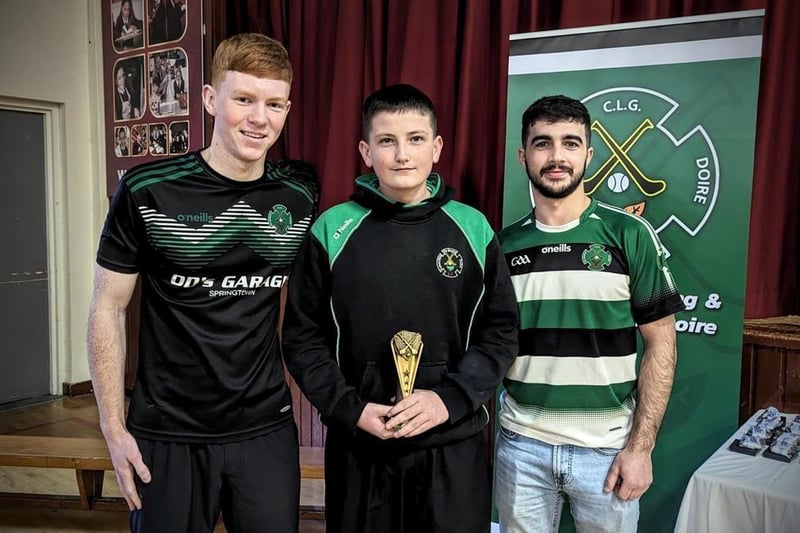 Daniel Doherty and Keelan Doherty present Finn McGrory with the U13 Player of the Year award.