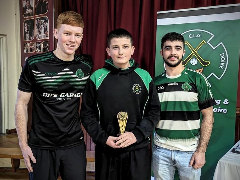 Daniel Doherty and Keelan Doherty present Finn McGrory with the U13 Player of the Year award.